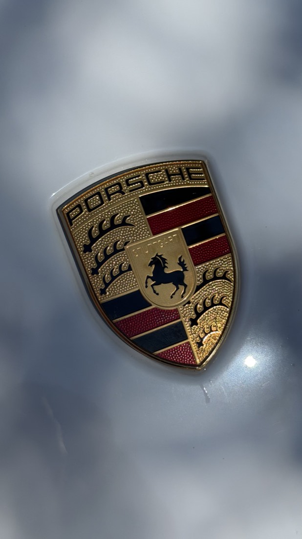 Porsche badge macro shot on glossy paint